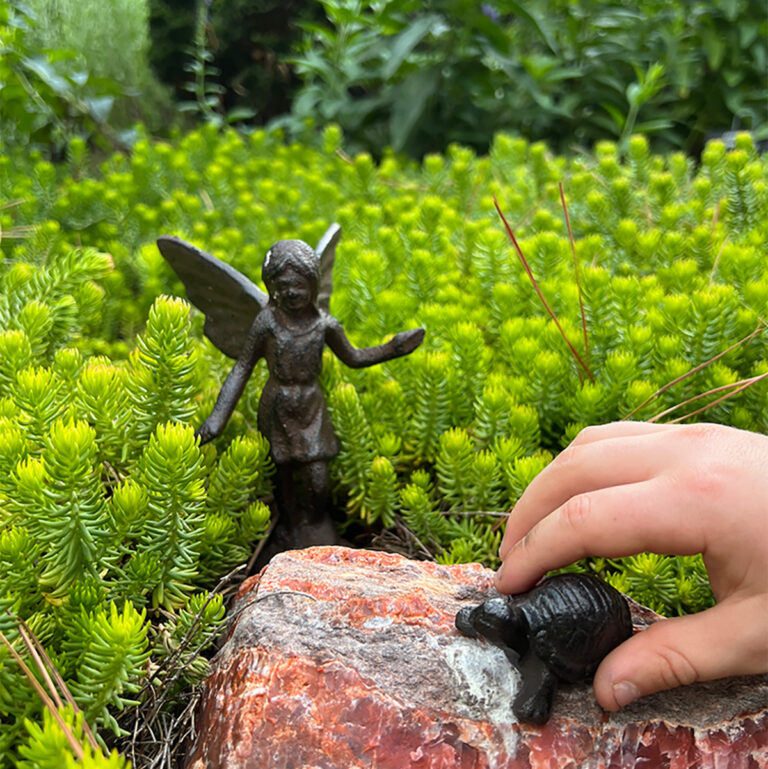 cast iron fairy in sedum in the garden